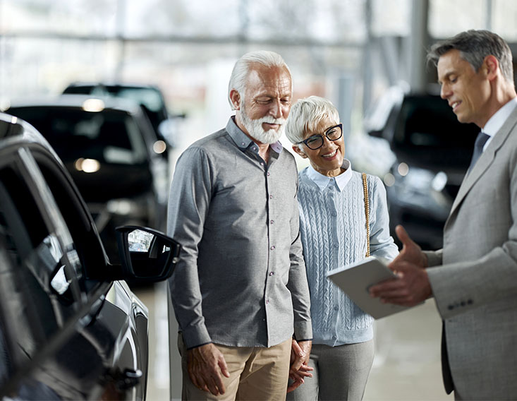 Mature couple financing a used car