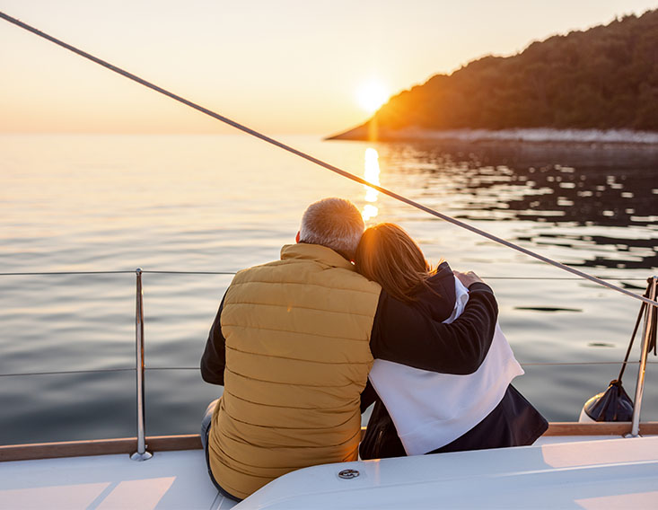 Couple watching sunset on a boat financed by First State Bank