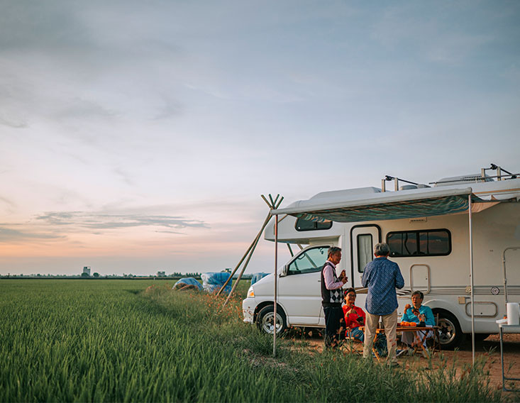 Family camping in an RV financed by First State Bank