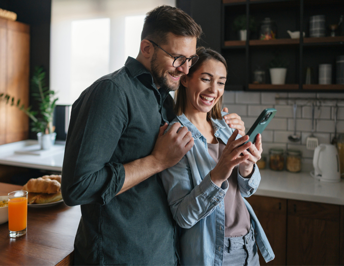 Couple using online banking with their Bank On Certified New Start Checking account.