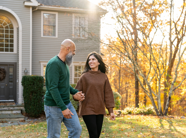 Couple looking at a house in the fall in St. Charles