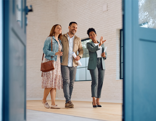 A couple browsing a new home with a realtor