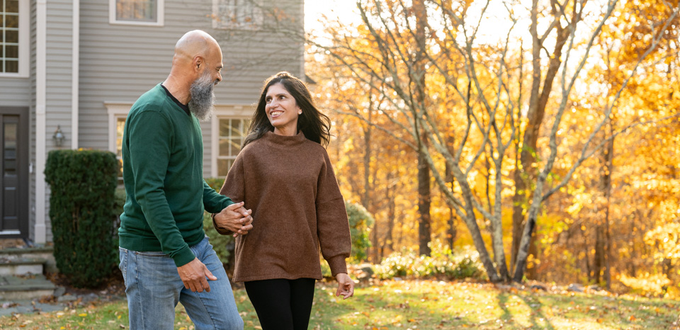 A couple is excitedly discussing a new home they just toured during the house hunting process.